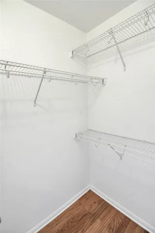 a kitchen with a refrigerator a stove top oven and cabinets