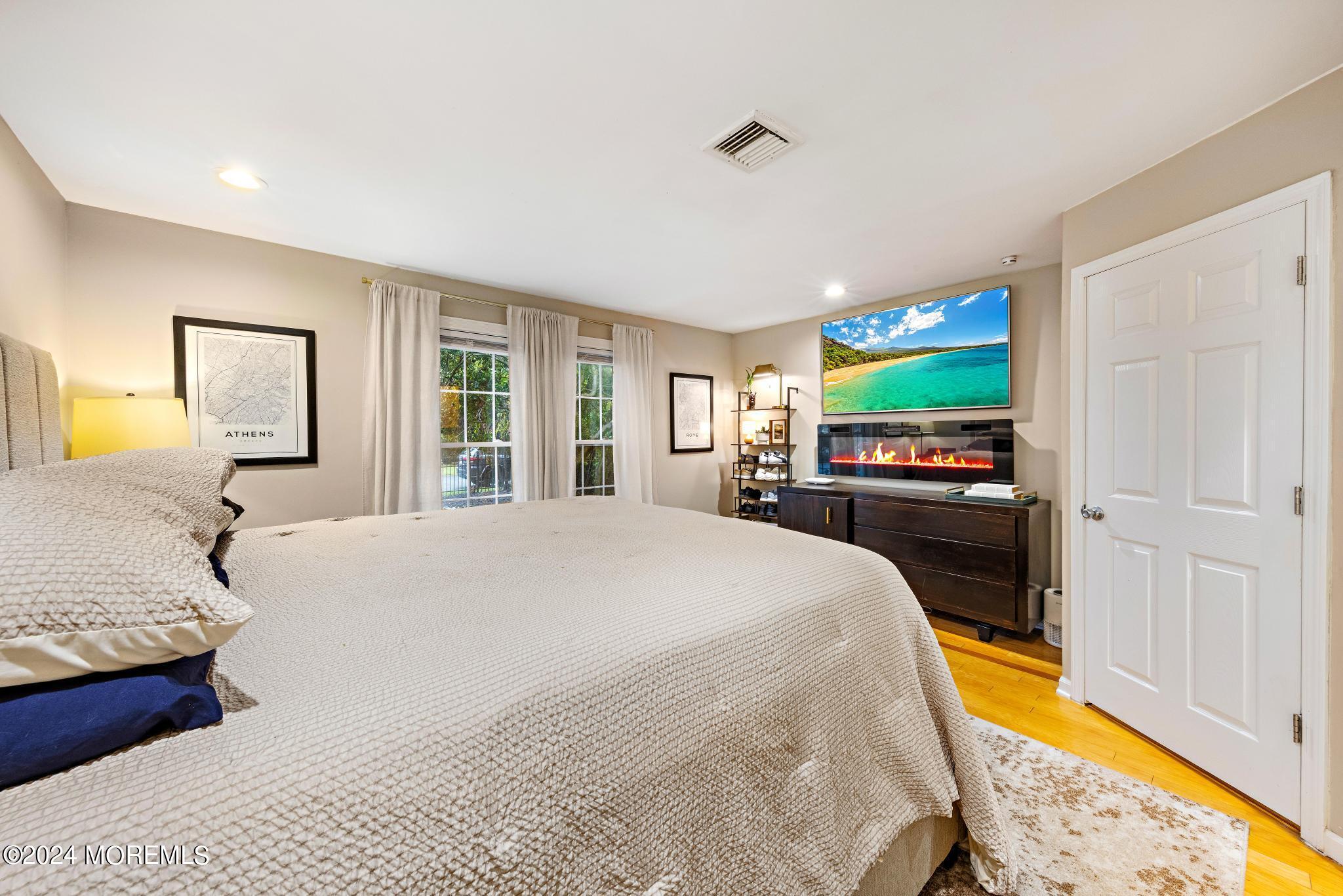 14 Seaton Road Toms River, NJ 08755 - Photo 23 of 59 a spacious bedroom with a bed and a flat screen tv