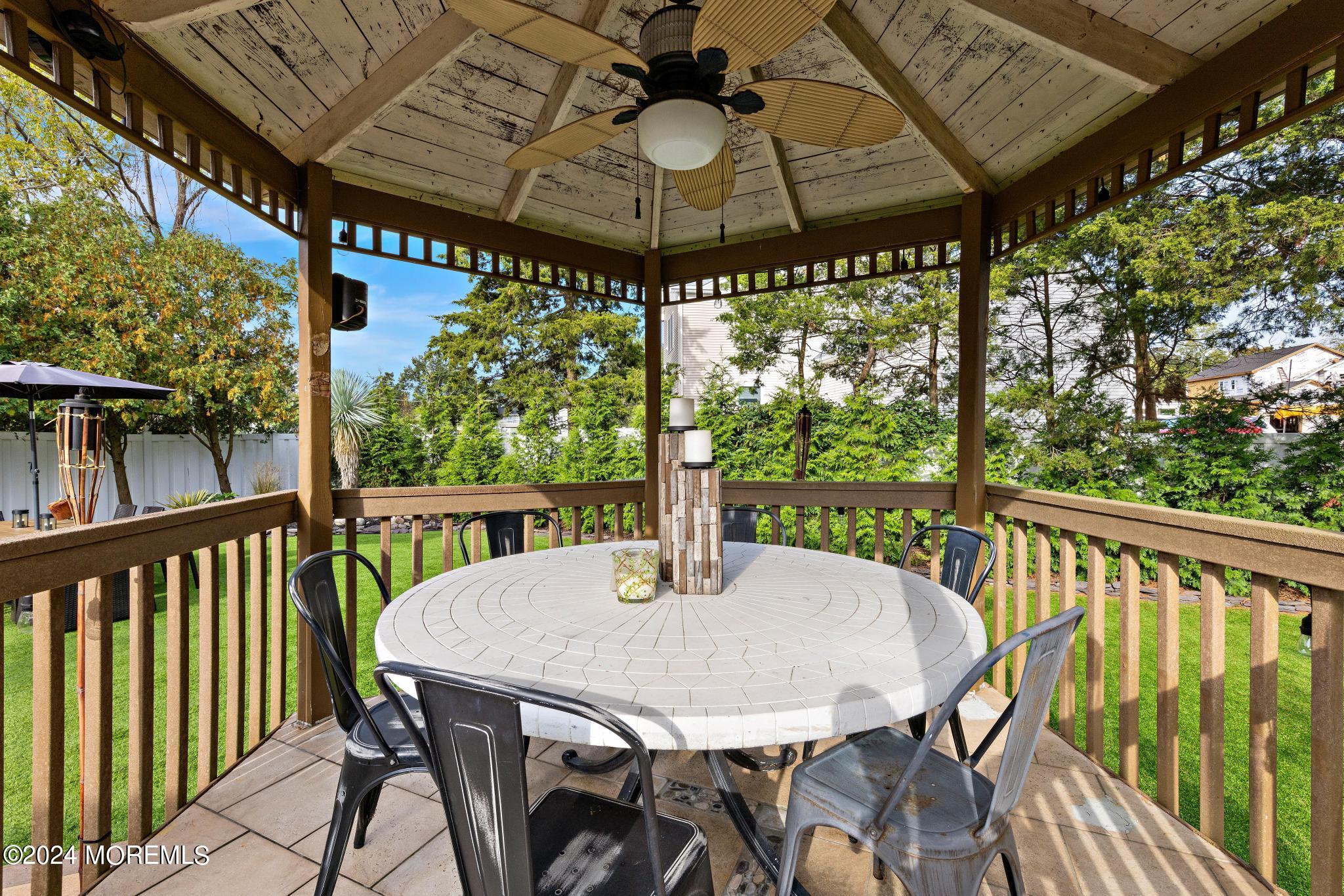 14 Seaton Road Toms River, NJ 08755 - Photo 37 of 59 a view of a patio with a table chairs and a table
