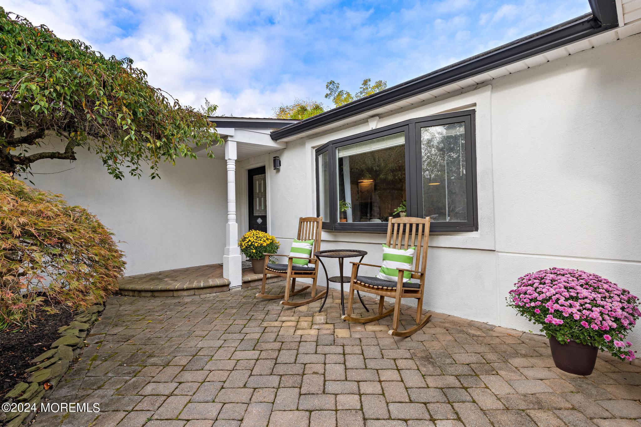 14 Seaton Road Toms River, NJ 08755 - Photo 5 of 59 a view of a patio with a table and chairs and potted plants