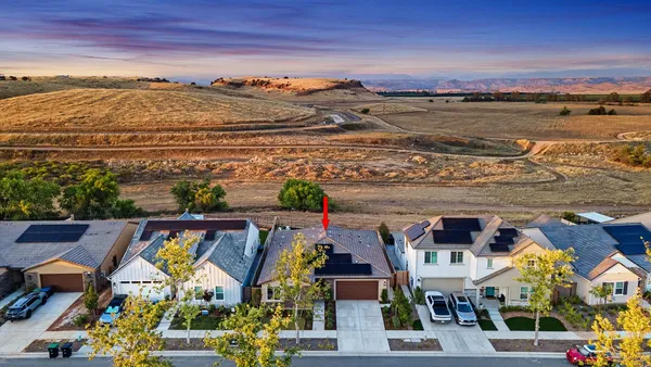 an aerial view of residential houses and outdoor space