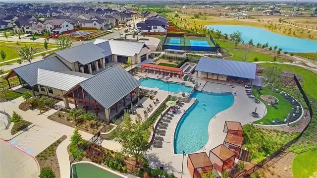 an aerial view of a house with outdoor space pool patio and ocean view