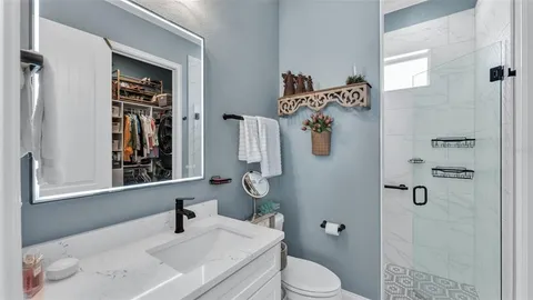 a bathroom with a sink toilet and shower