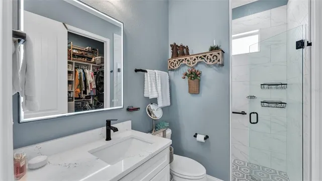 a bathroom with a sink toilet and shower