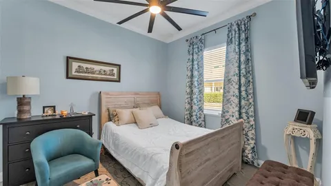 a bedroom with a bed couch and window