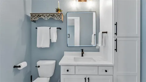 a bathroom with a sink toilet and mirror