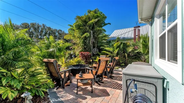 a view of a backyard with table and chairs and potted plants