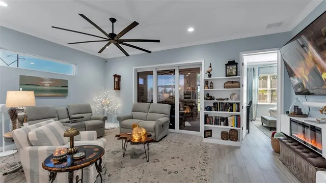 a living room with furniture a bookshelf and a book shelf