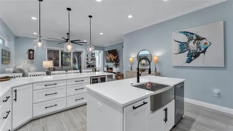 a kitchen with a sink a counter space and cabinets