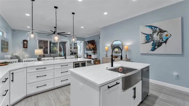a kitchen with a sink a counter space and cabinets