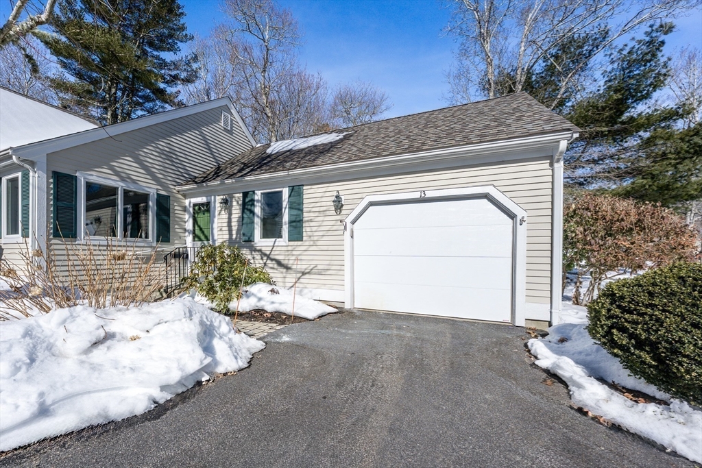 13 Pga Lane, Unit 424 Mashpee, MA 02649 - Photo 18 of 19 a front view of a house with a yard and garage