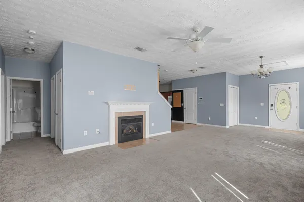 a view of a livingroom with a fireplace and window