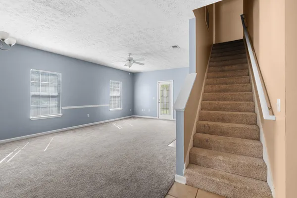 a view of an empty room with stairs