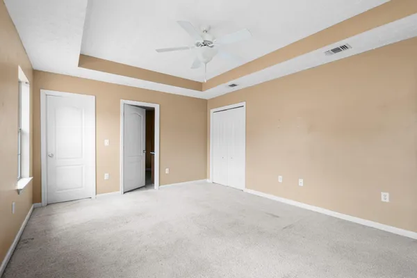 a view of an empty room with a ceiling fan