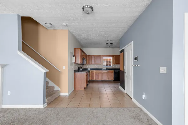 a view of kitchen with sink and refrigerator