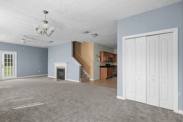 wooden floor in an empty room and a ceiling fan