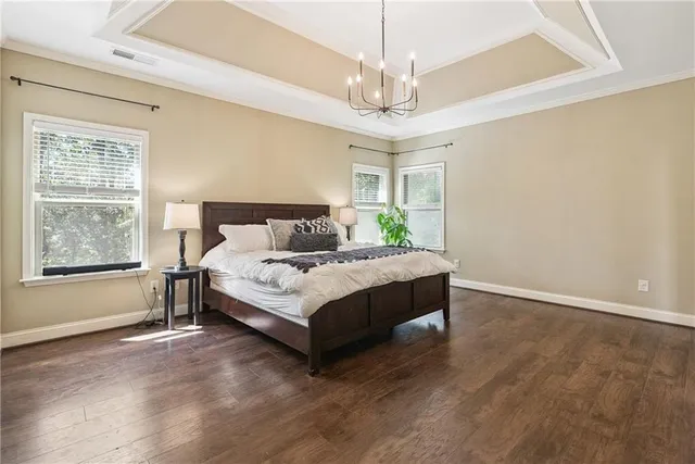 a spacious bedroom with a bed and window