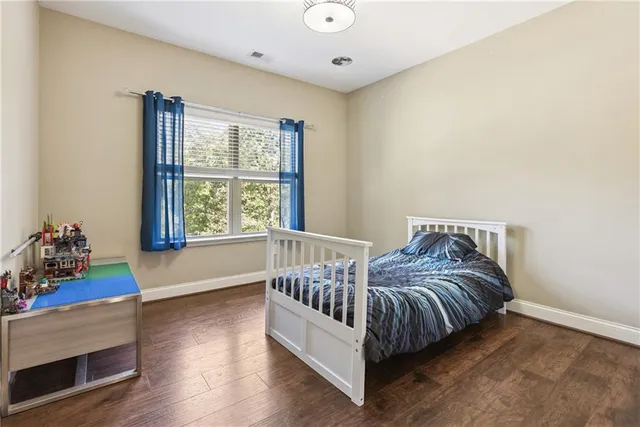 a bedroom with furniture and a large window
