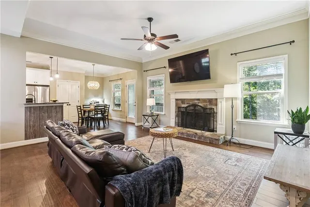 a living room with furniture a flat screen tv and a fireplace