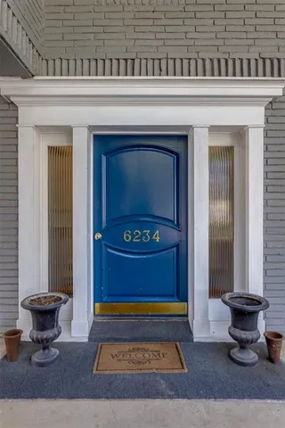 a white kitchen with granite countertop stainless steel appliances