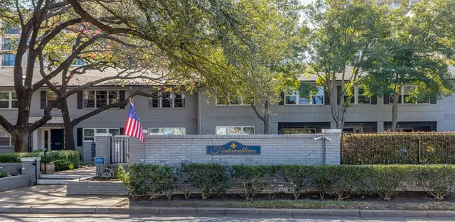 a sign that is on the wall in front of a building