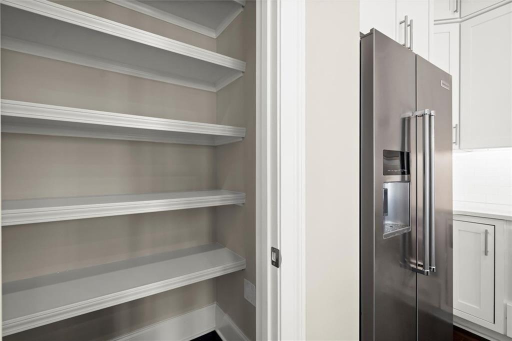293 Thompson Street Alpharetta, GA 30009 - Photo 25 of 71 a view of walk in closet with empty racks