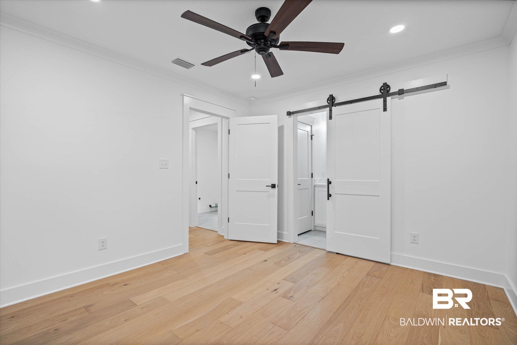 11 Schwaemmle Drive Mobile, AL 36608 - Photo 18 of 32 Unfurnished bedroom with a barn door, ornamental molding, light wood-style floors, recessed lighting, and a ceiling fan