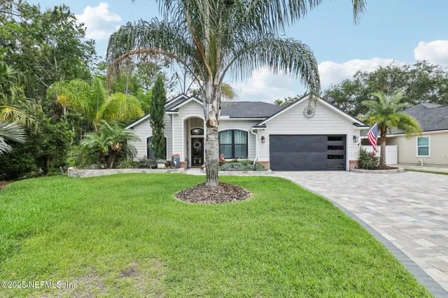 a front view of a house with a yard and garage