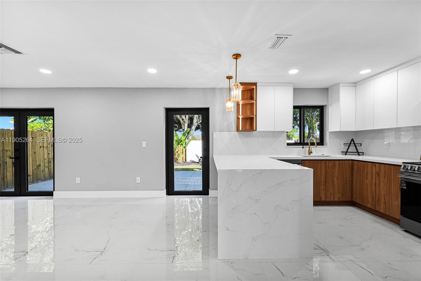10823 Southwest 147th Court Miami, FL 33196 - Photo 23 of 100 a large kitchen with stainless steel appliances a large counter top a sink and a refrigerator