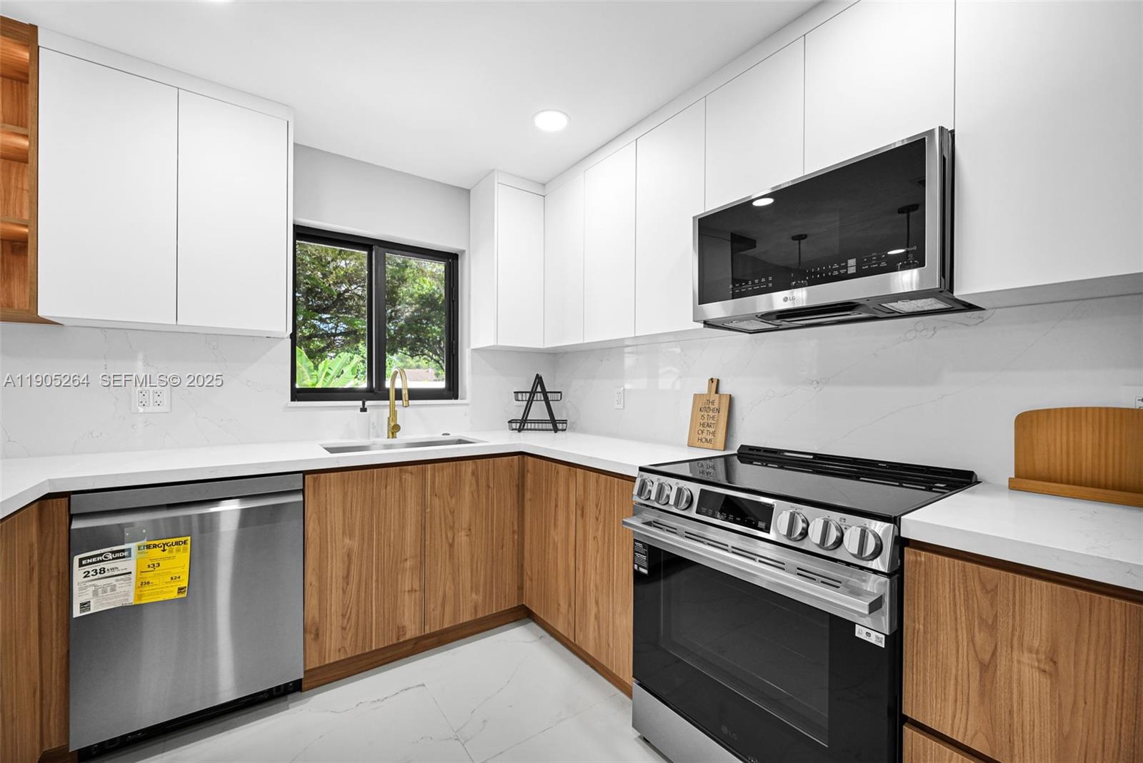 10823 Southwest 147th Court Miami, FL 33196 - Photo 29 of 100 a kitchen with stainless steel appliances a sink stove and microwave