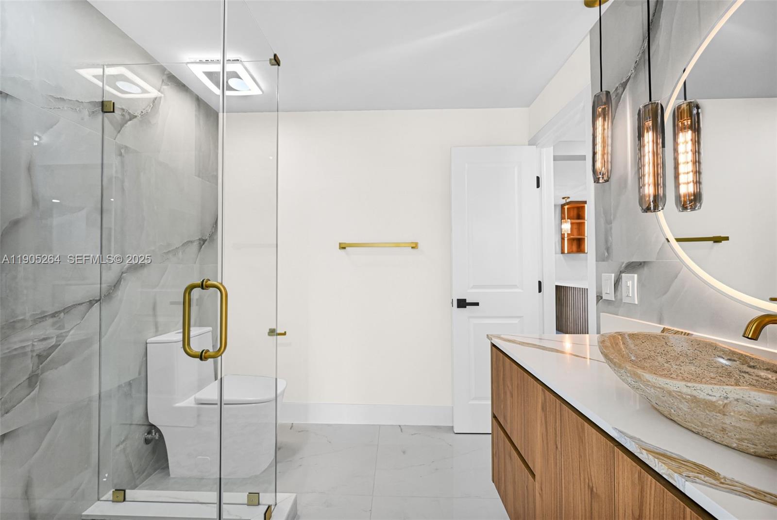 10823 Southwest 147th Court Miami, FL 33196 - Photo 45 of 100 a bathroom with a granite countertop sink a mirror and shower