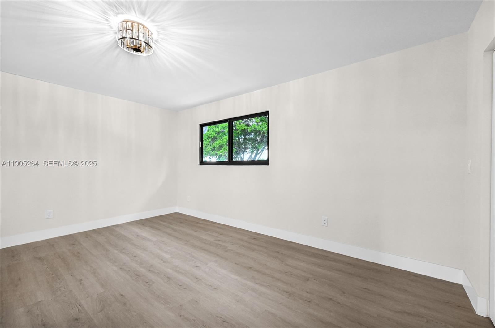 10823 Southwest 147th Court Miami, FL 33196 - Photo 56 of 100 an empty room with wooden floor and windows