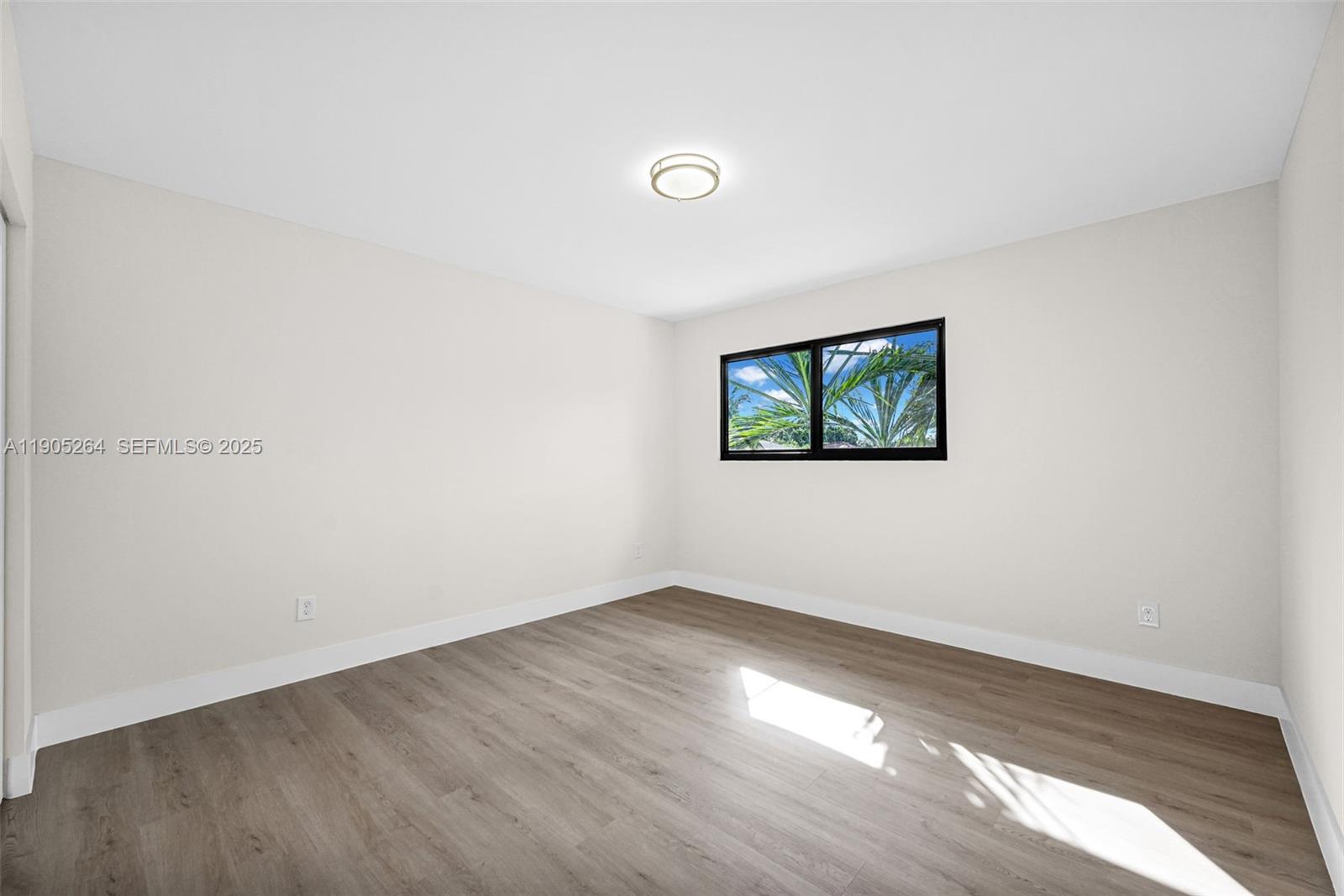 10823 Southwest 147th Court Miami, FL 33196 - Photo 69 of 100 an empty room with wooden floor and windows