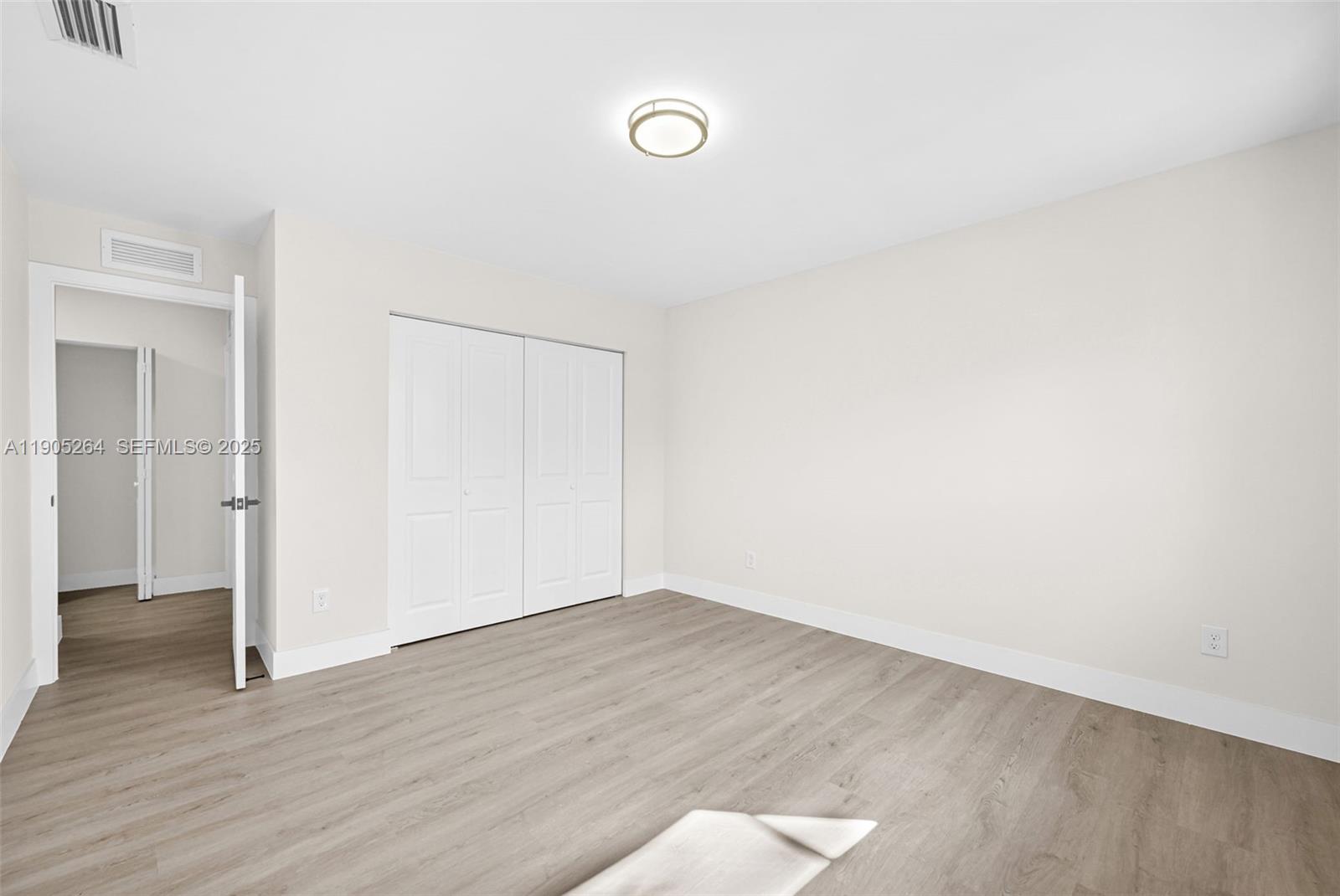 10823 Southwest 147th Court Miami, FL 33196 - Photo 70 of 100 a view of an empty room with wooden floor