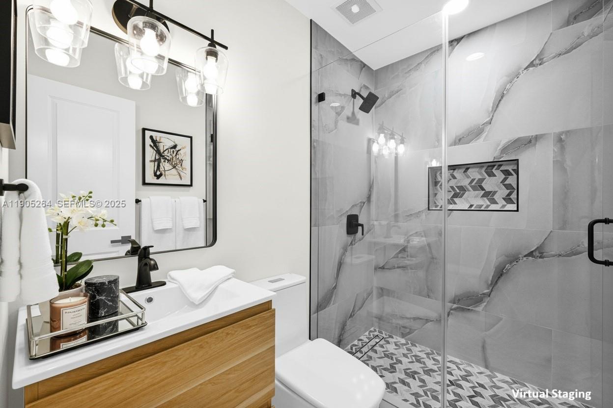 10823 Southwest 147th Court Miami, FL 33196 - Photo 7 of 100 a bathroom with a sink a toilet and shower