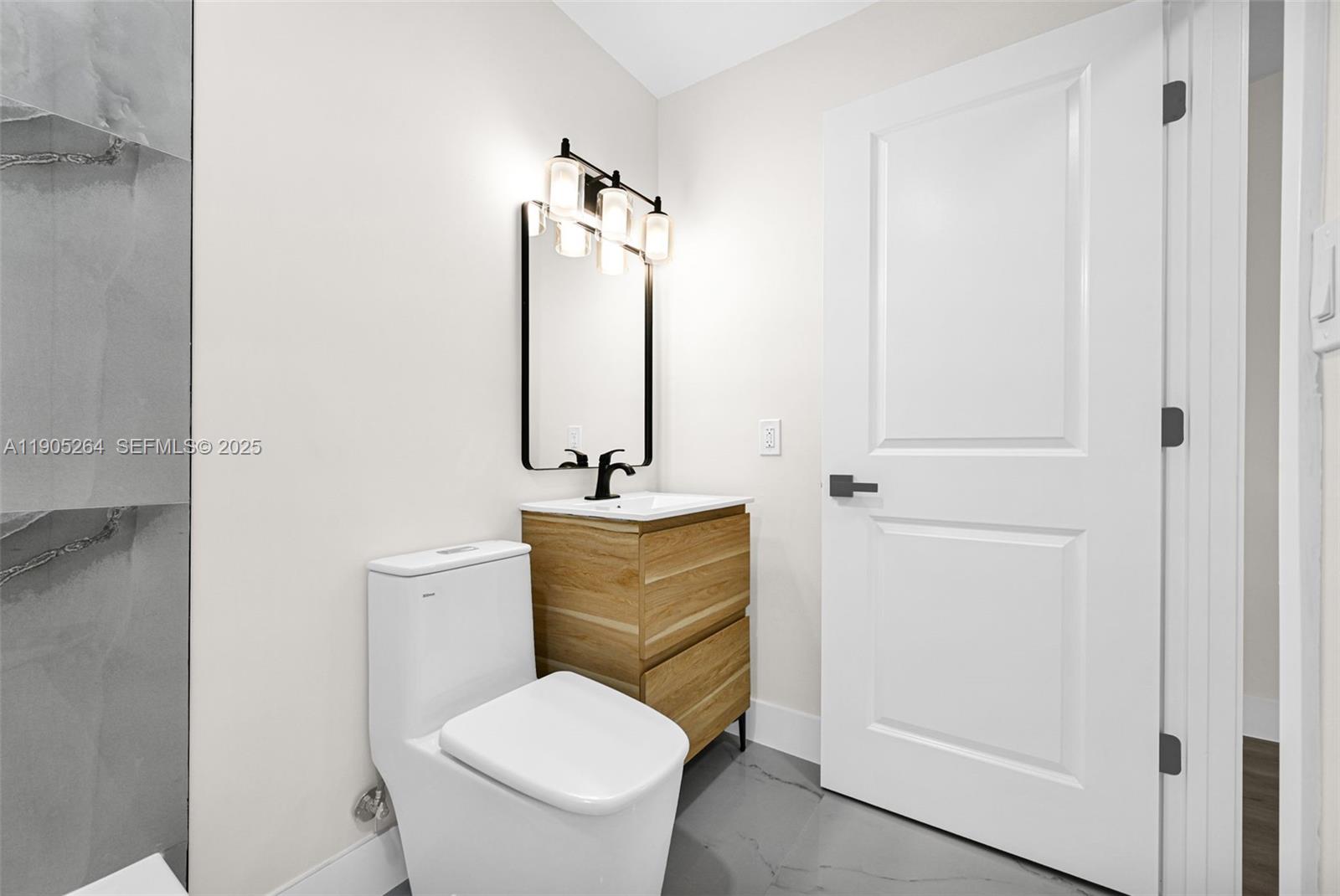 10823 Southwest 147th Court Miami, FL 33196 - Photo 73 of 100 a bathroom with a toilet sink and mirror