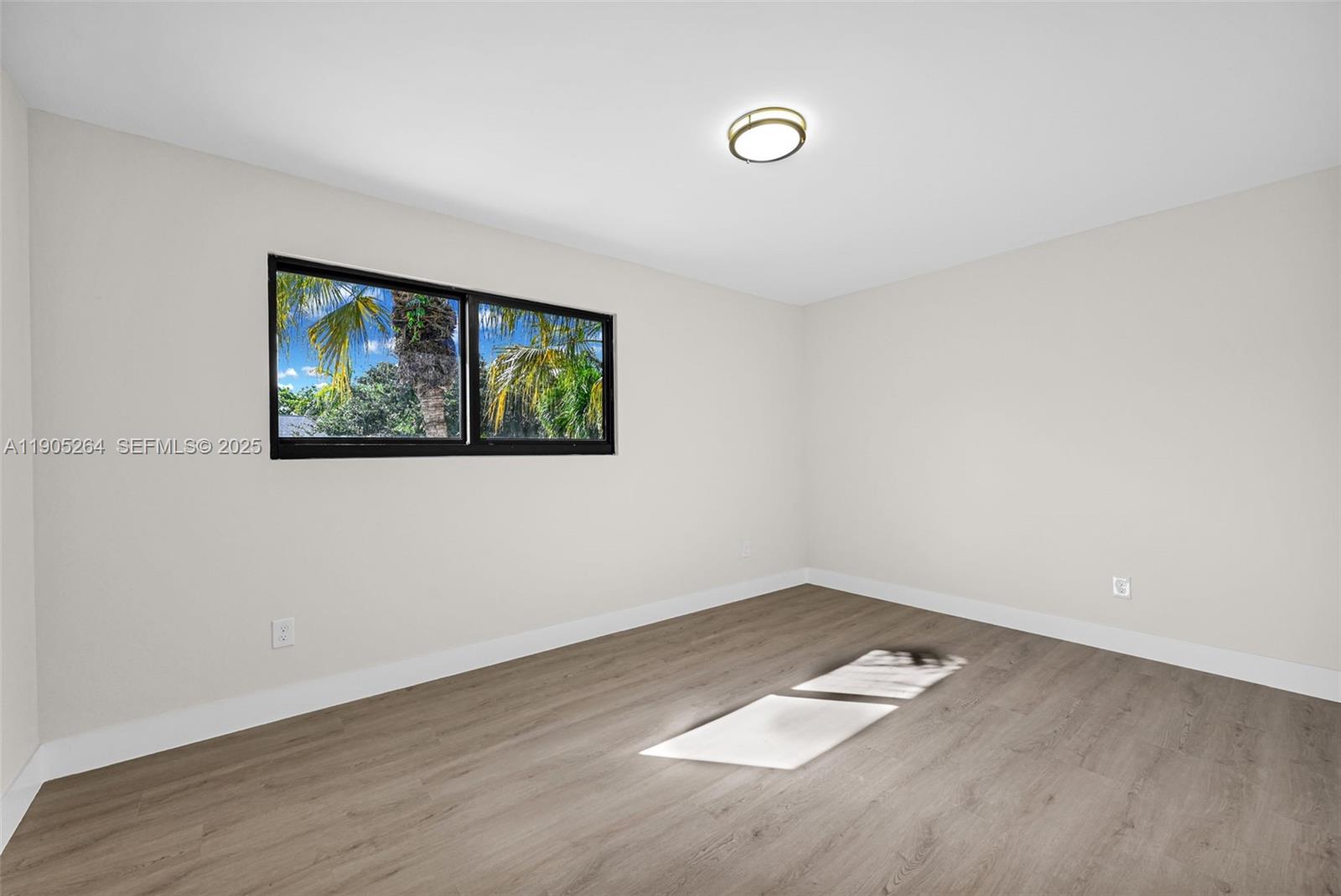 10823 Southwest 147th Court Miami, FL 33196 - Photo 75 of 100 an empty room with wooden floor and window