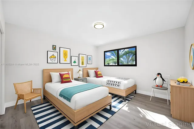 a large kitchen with stainless steel appliances a large counter top a sink and a refrigerator