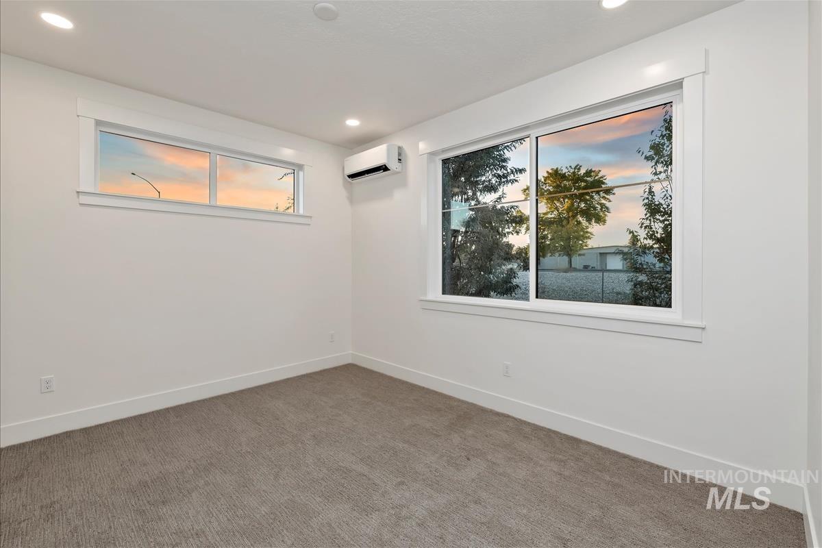 3243 West Moore Street Boise, ID 83702 - Photo 25 of 38 Unfurnished room with carpet flooring, recessed lighting, and a wall mounted air conditioner