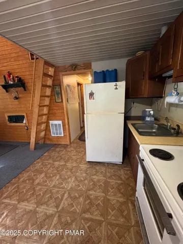 a kitchen with a refrigerator and a stove