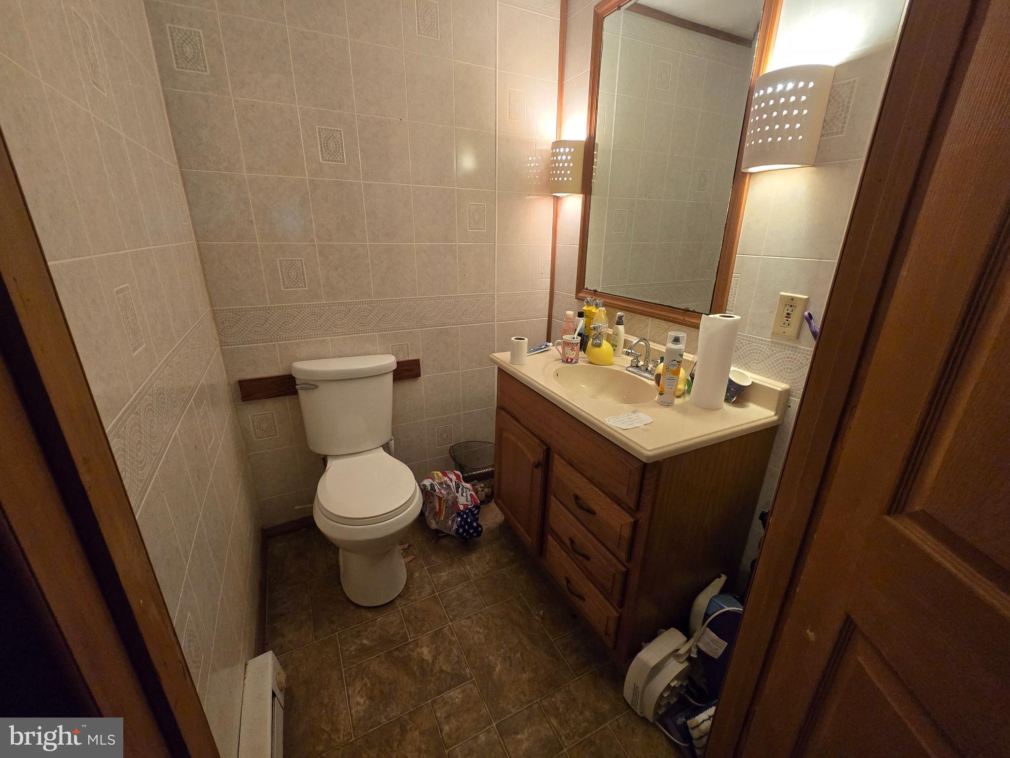3165 Springfield Pike Springfield, WV 26763 - Photo 11 of 16 a bathroom with a toilet sink and mirror