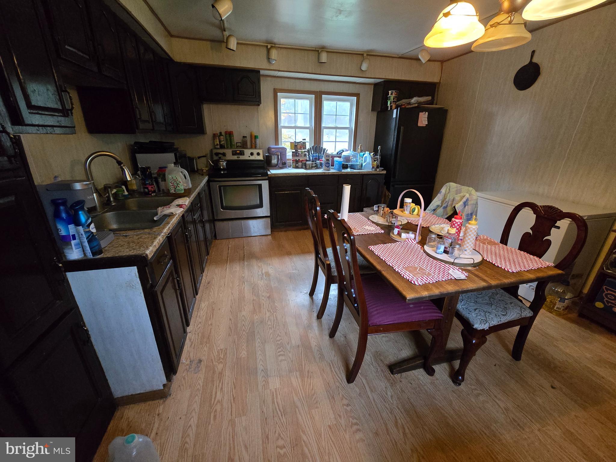 3165 Springfield Pike Springfield, WV 26763 - Photo 8 of 16 a view of a dining room with furniture and wooden floor
