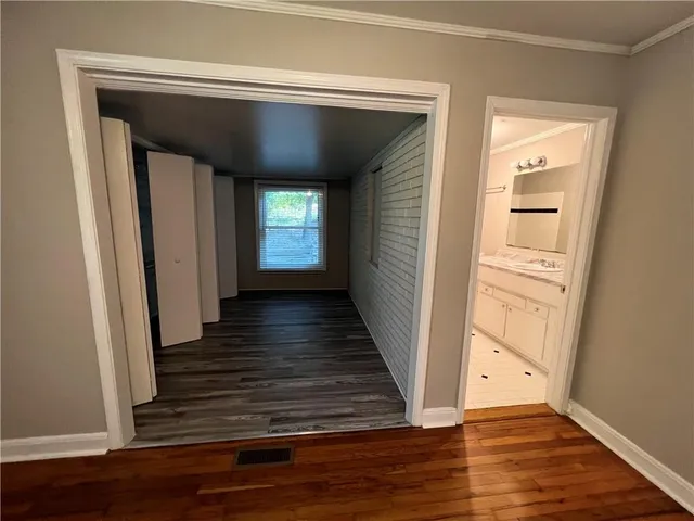 a view of a hallway with wooden floors and a fireplace