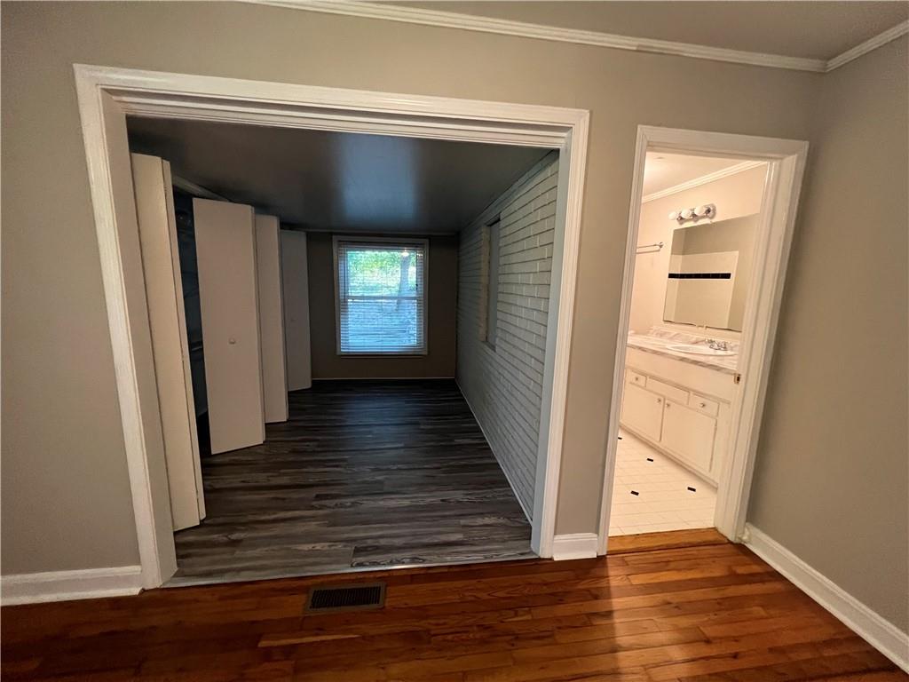 434 Christopher Drive Gainesville, GA 30501 - Photo 9 of 11 a view of a hallway with wooden floors and a fireplace