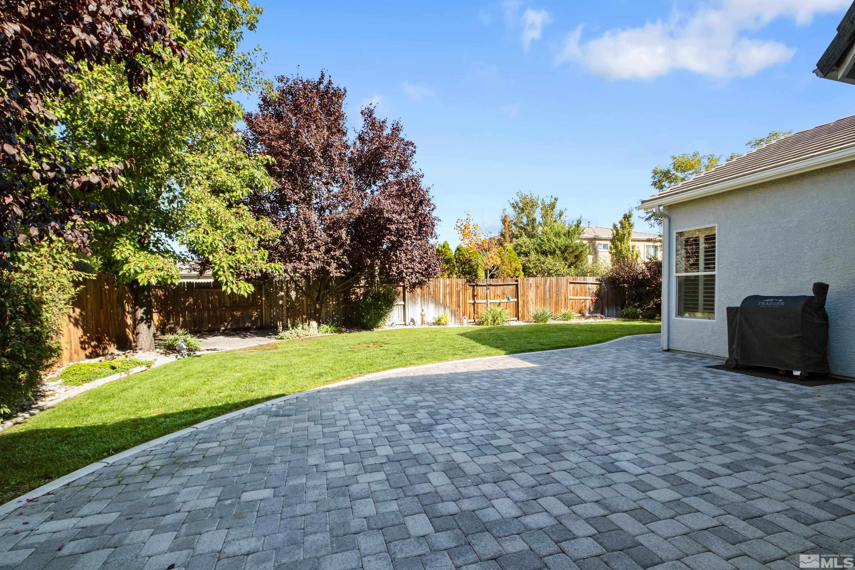 1651 Caliterra Way Reno, NV 89521 - Photo 26 of 30 a view of a house with backyard and trees
