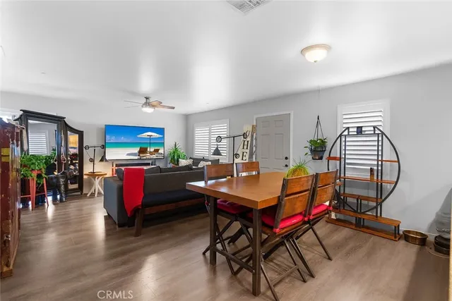 a living room with dining room and wooden floor