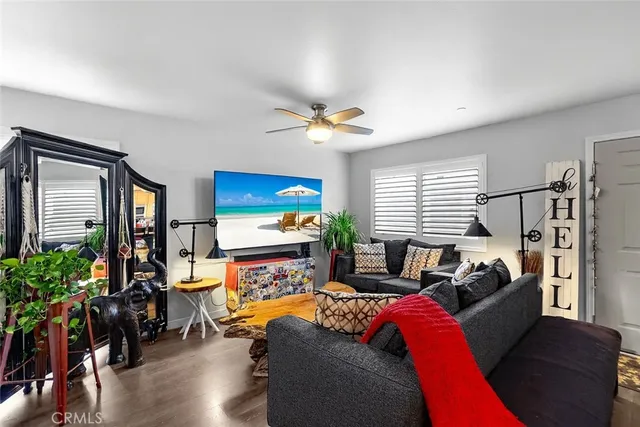 a living room with furniture a window and a flat screen tv