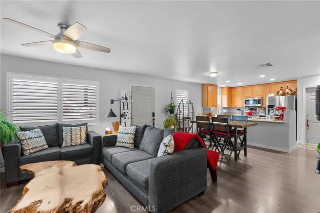 a living room with furniture and kitchen view
