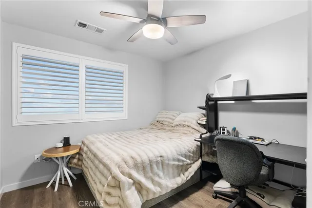 a bedroom with a bed and a chair