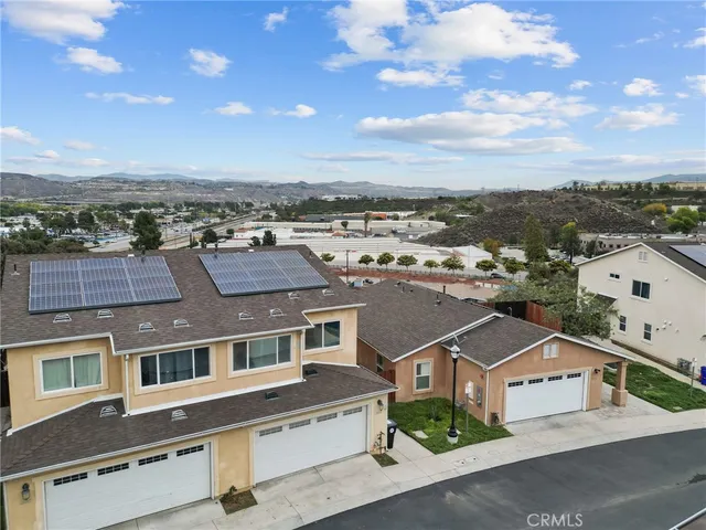 an aerial view of residential houses with a city view